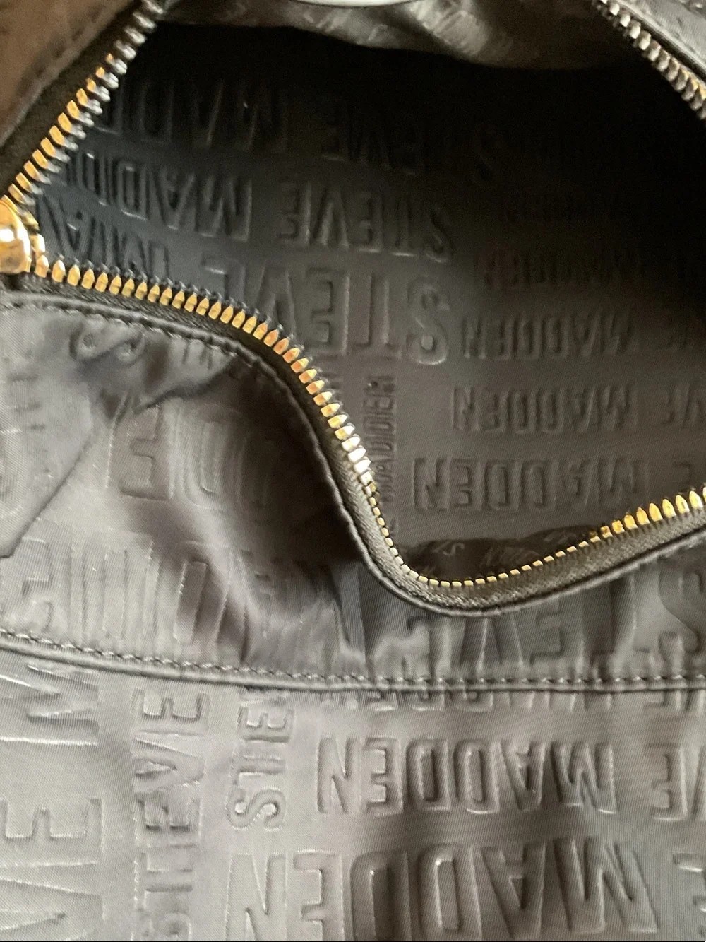 Steve Madden Black Embossed Logo Backpack with Gold Zipper